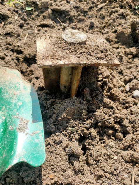 metal round box thing in my backyard|Metal square in garden with a round thing buried 8 cm .